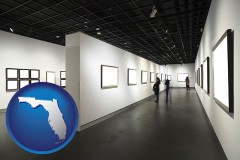 florida map icon and people viewing paintings in an art museum
